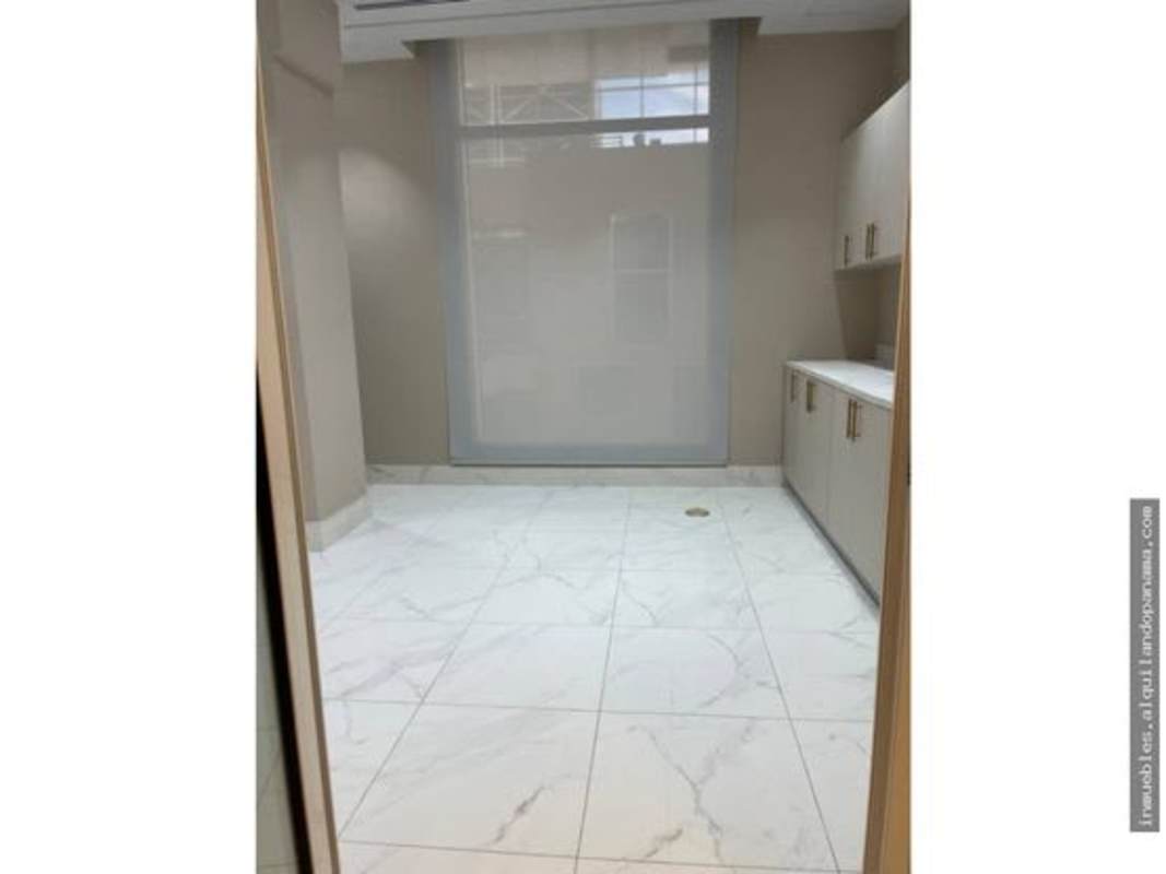 Beige cabinetry kitchenette and marble flooring inside Town Center commercial medical office Panama