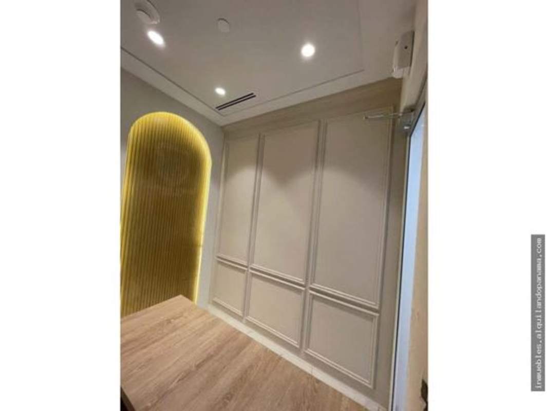 Minimalist hallway with marble flooring, built-in cabinets, and modern recessed lighting in Costa del Este Town Center