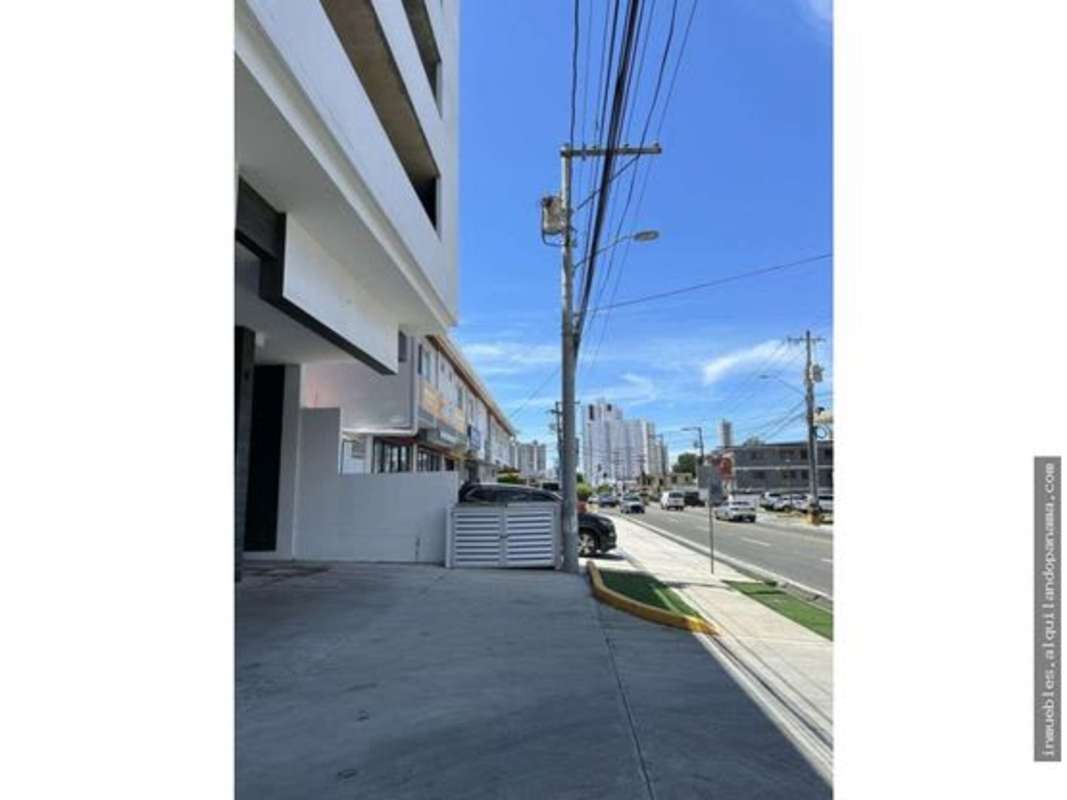 Modern storefront and sidewalk facing busy Avenida Lefevre Panama City with street view