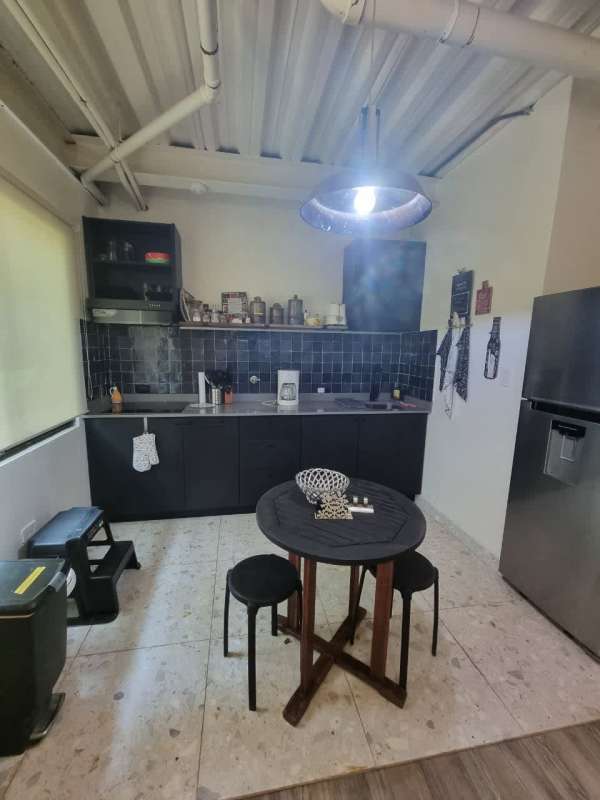 Black cabinets exposed ceiling pipes marble floor PH Clayton Park Panama