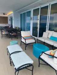 Contemporary living and dining area with floor-to-ceiling ocean views at Santa Clara beachfront condominium