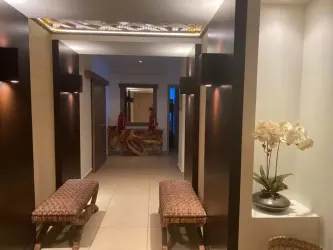 Dining area with glass wall showcasing Pacific oceanfront views in Santa Clara condo