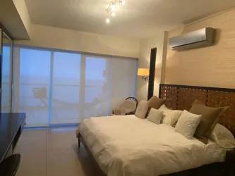 Bedroom with large sliding doors opening to ocean views in beachfront condo Santa Clara Panama