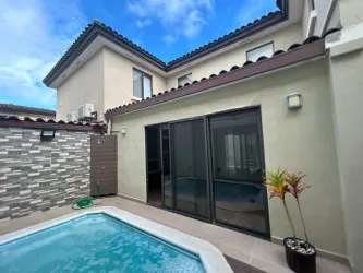Bright living room with sliding glass doors to terrace in Panama Pacifico house