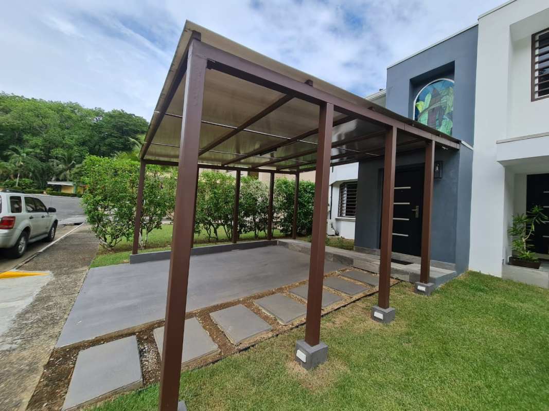 Kitchen with granite counters, blue pendant lights, stainless appliances, window in Clayton Panama