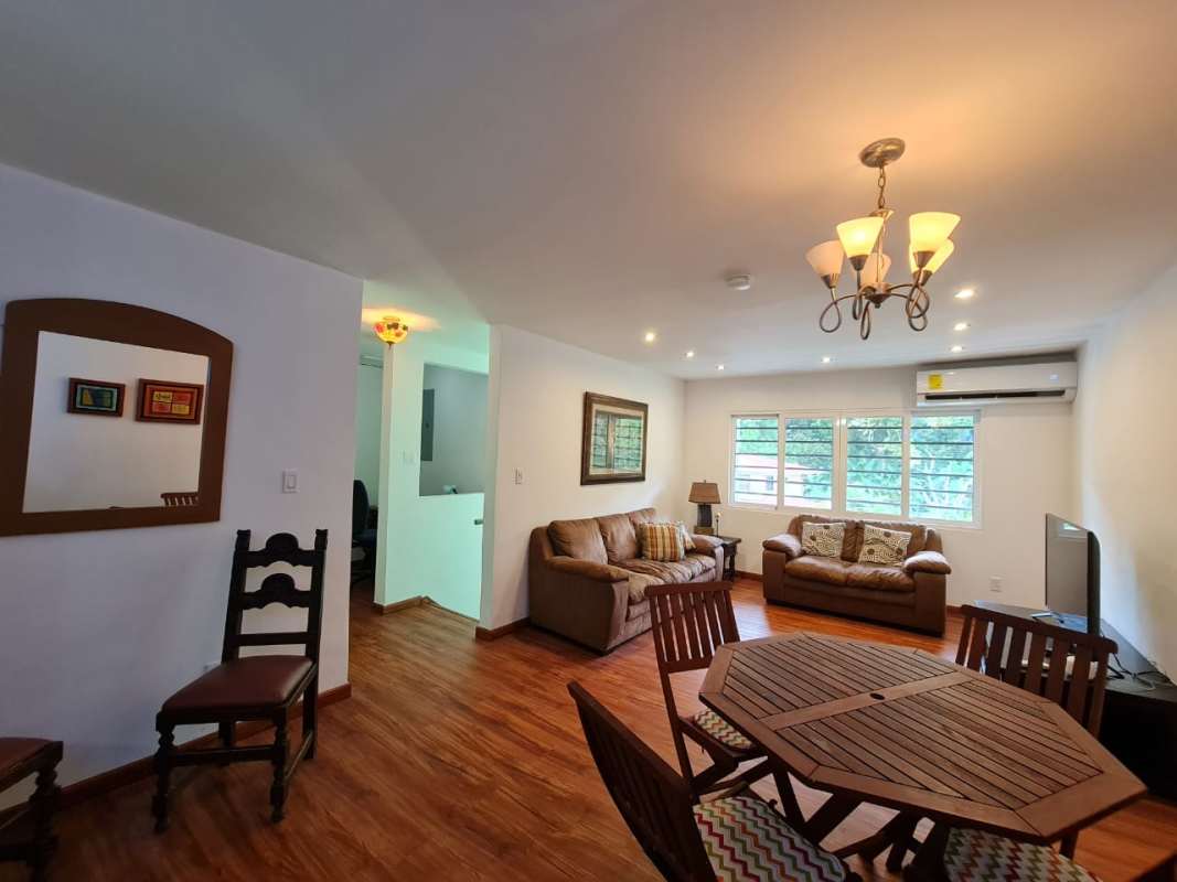 Open living and dining space with wood flooring and large windows Clayton Panama