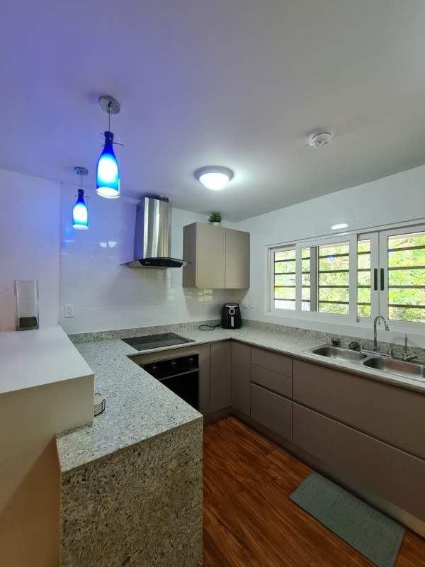 Modern staircase with wooden steps and metal railing in Clayton furnished rental