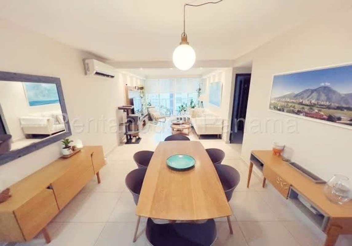 Modern kitchen with stainless appliances and wood cabinetry in PH Genesis Tower apartment