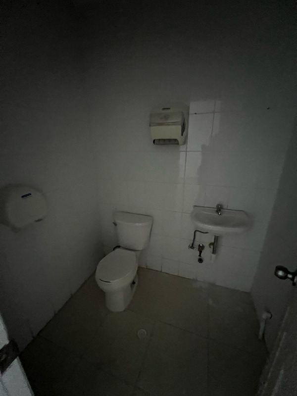 Glass door entry to retail commercial space with tiled exterior and signage in Marbella Panama