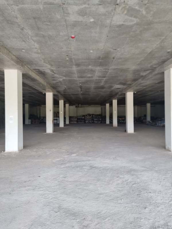 Unfinished commercial interior with concrete floor and support columns in Costa Sur shopping center