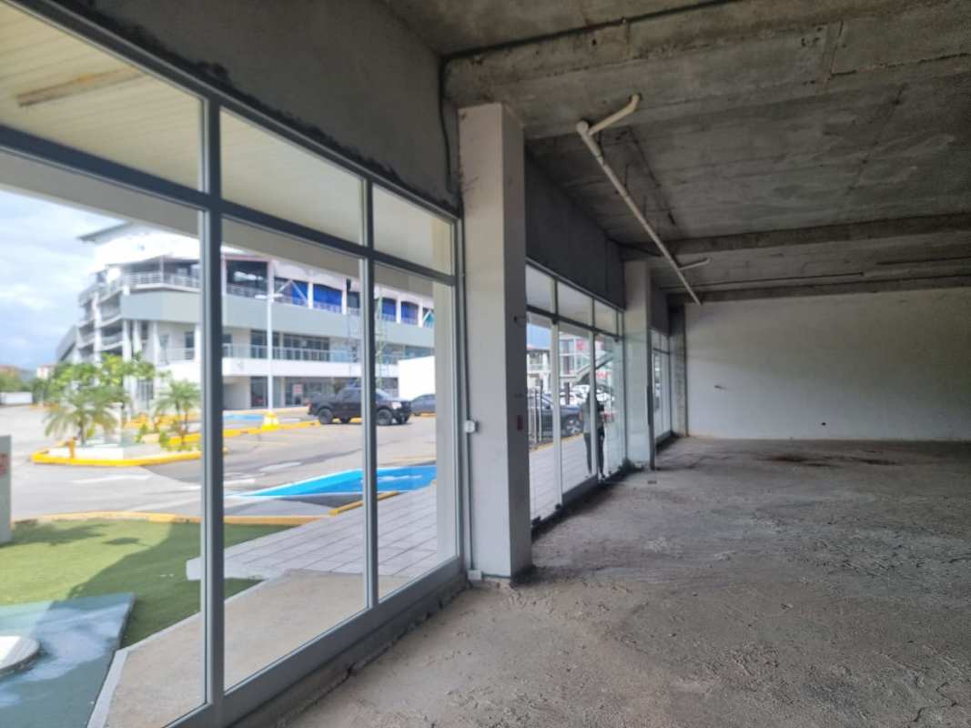 Large retail commercial grey space interior with concrete ceiling and glass doors in Costa Sur Panama City