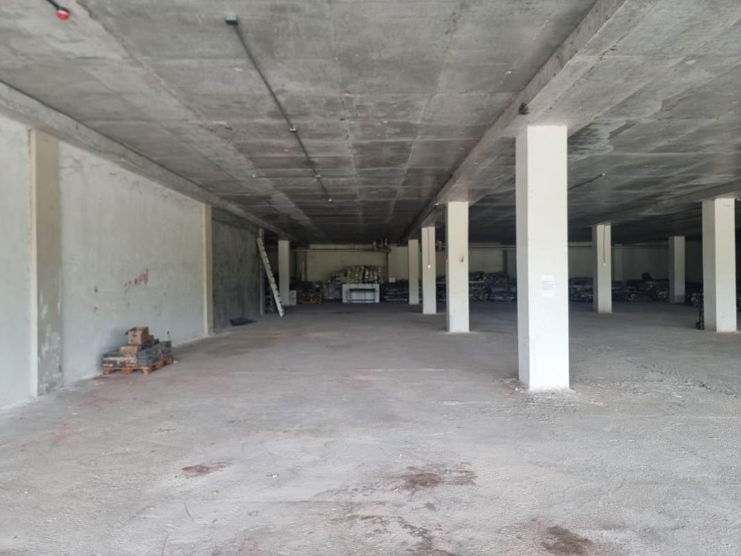 Unfinished large interior with exposed concrete ceiling and industrial style in Costa Sur shopping plaza Panama