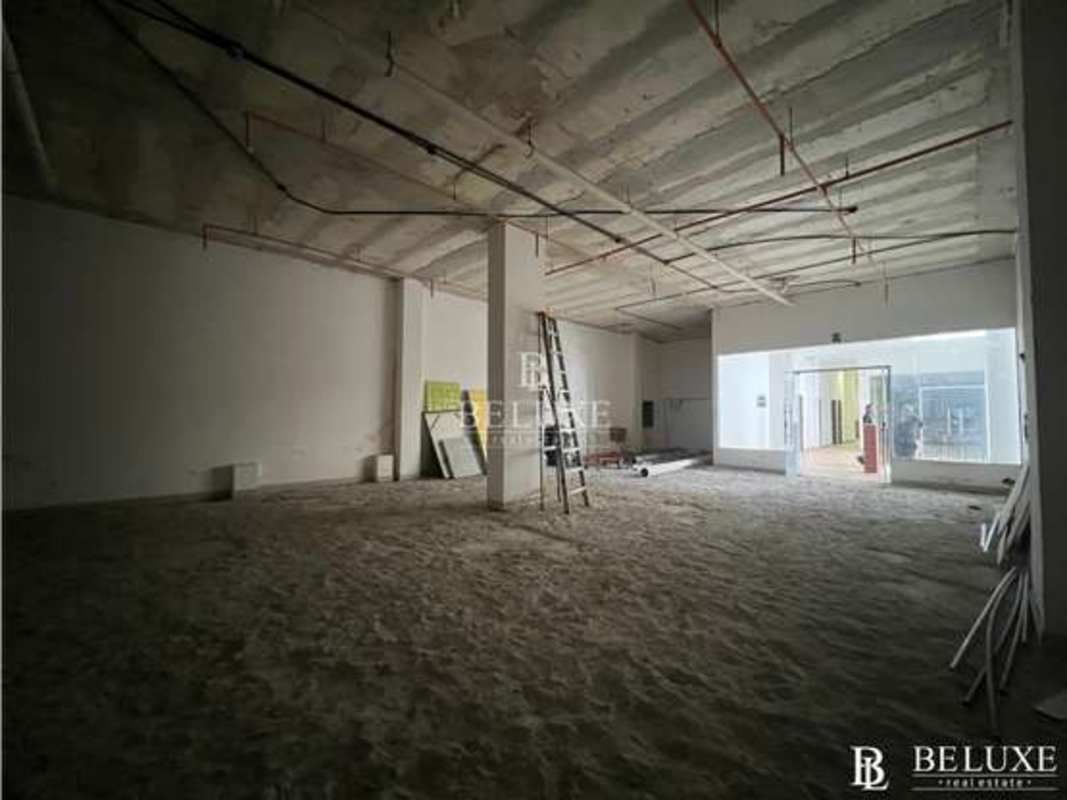Commercial floor with unfinished interior, large windows, exposed ceiling at Plaza Bella Vista