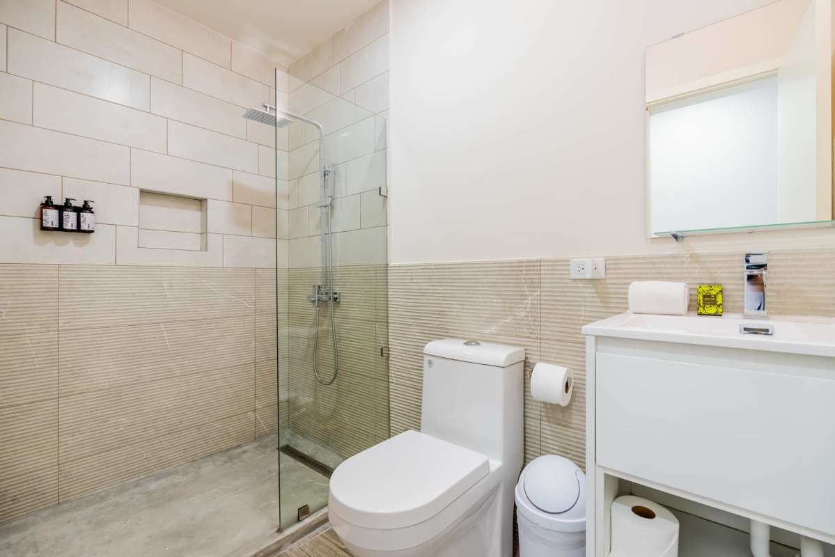 Bathroom with glass shower rain head wall dispensers Casa Lefevre Casco Viejo Panama