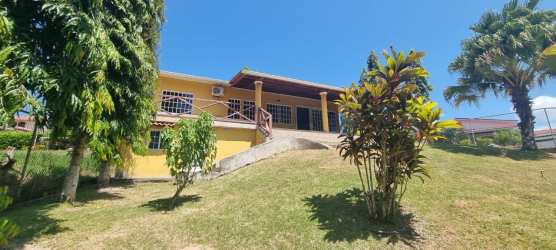 Charming yellow house with covered porch lush gardens hillside lot Valle Village San Carlos