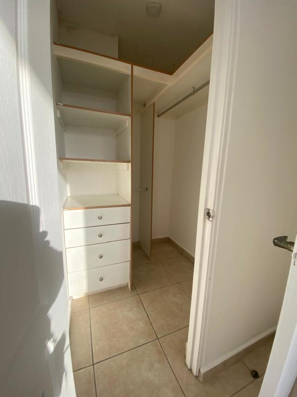 Bedroom with large window, built-in closet, tiled floor, city skyline view, PH San Francisco Bay