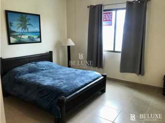 Furnished bedroom with bed, closet, ensuite bath at PH Balcones Playa Blanca Panama