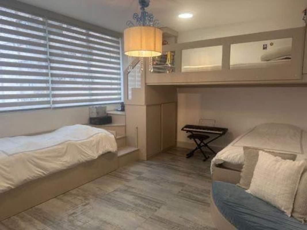 Secondary bedroom with floor-to-ceiling windows city skyline view PH Peninsula Panama City