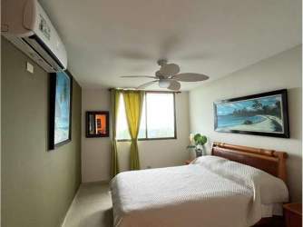 Large balcony with ocean view and ceiling fan in Playa Blanca beachfront condominium