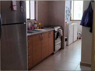 Bedroom featuring closet, ceiling fan, large window with ocean view in Playa Blanca