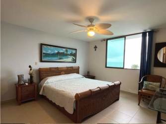 Bright living dining room with balcony access overlooking ocean in PH Balcones Playa Blanca condo