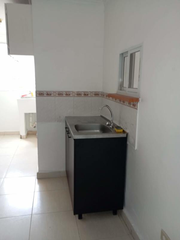 Simple kitchen area with sink, tile backsplash, and refrigerator space PH Luna del Río