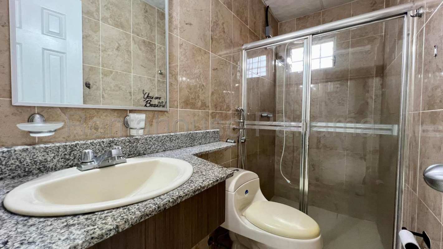Modern bathroom with granite countertop mirror and shower Ciudad del Lago Panama