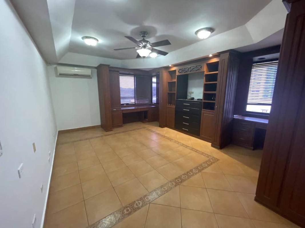 Home office area with custom wood cabinetry, ceiling fan, large windows Dos Mares Panama