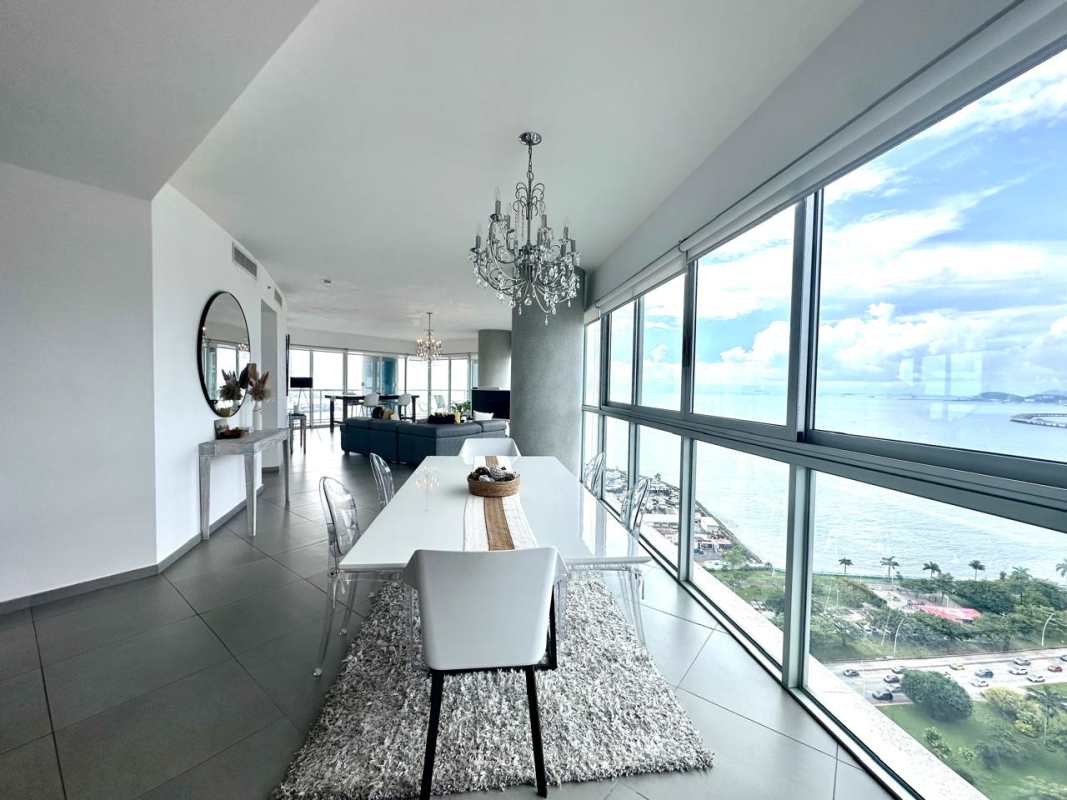 Bright living room with floor-to-ceiling glass and panoramic views at Yacht Club Tower Panama City