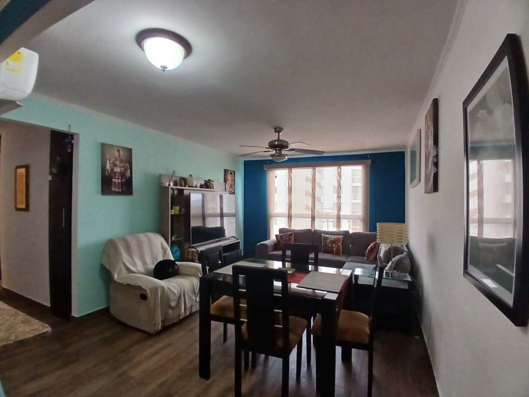 Living room with large windows, ceiling fan, and terrace access in Villa Zaita Panama apartment