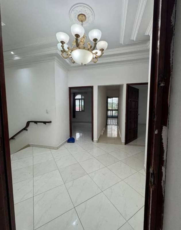 Indoor staircase with tiled steps, dark wood railing in residential house Altos del Chase Panama