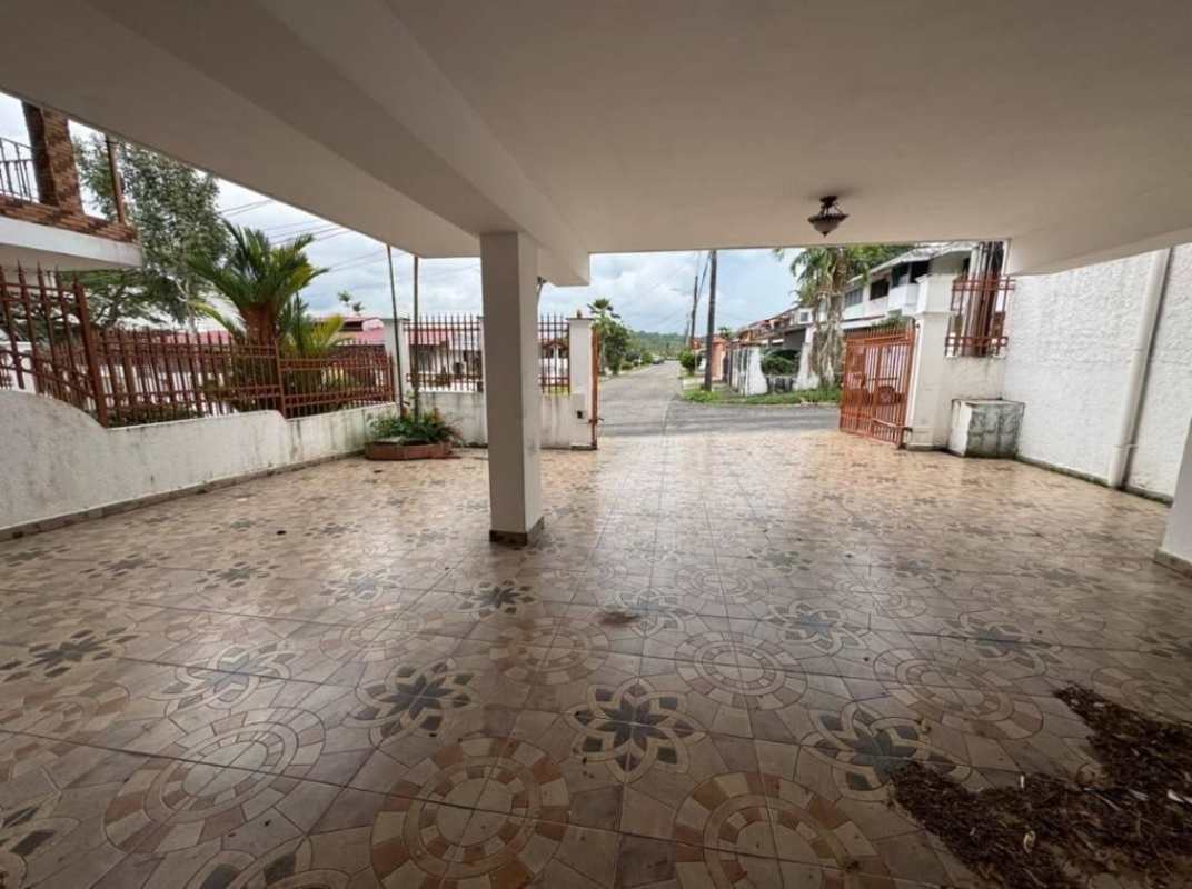 Covered carport with patterned tiles, iron gate, secured parking Altos del Chase Panama