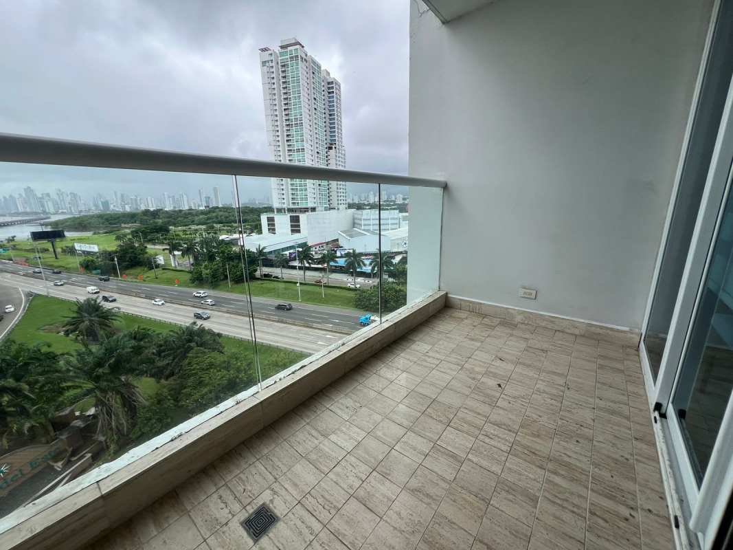 Spacious apartment balcony with glass railing overlooking city skyline in Costa del Este Panama PH The Regent