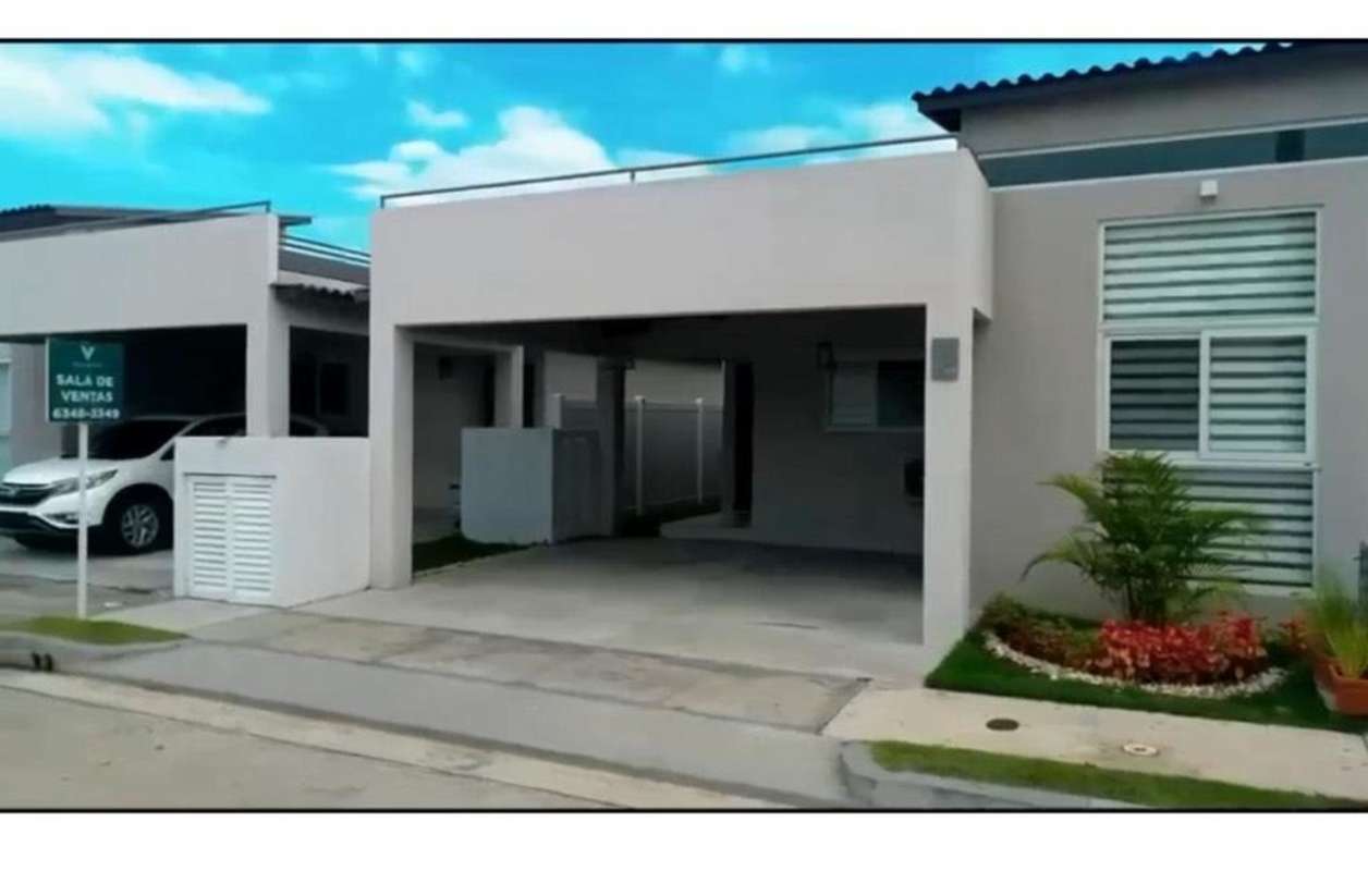 Single-level home exterior with covered carport and landscaped garden Costa Sur Panama