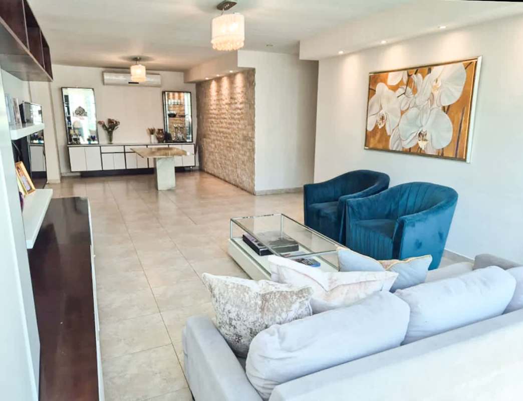 Living area with stone accent wall and contemporary decor in Mystic Point apartment Panama City