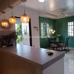 Open living dining space with tile flooring and bright windows in Villa Dora Chiriquí Panama