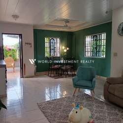 Covered backyard patio facing green garden area in Villa Dora David Panama house