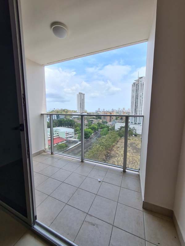 Bright living dining area with sliding glass door to balcony at PH Condado Gardens Panama