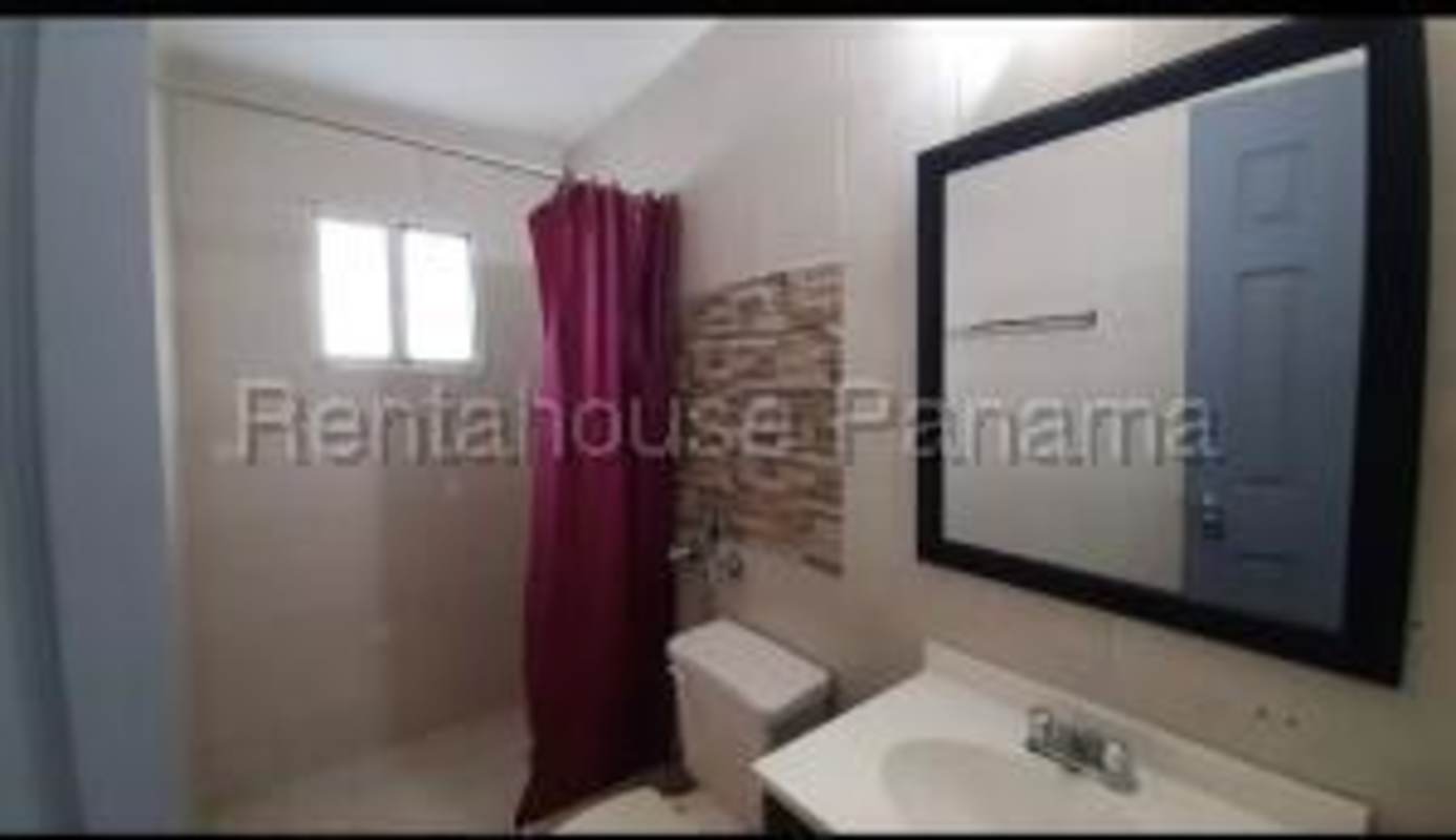 Modern bathroom with shower, mirror, pedestal sink in PH Royal Hill Panama City