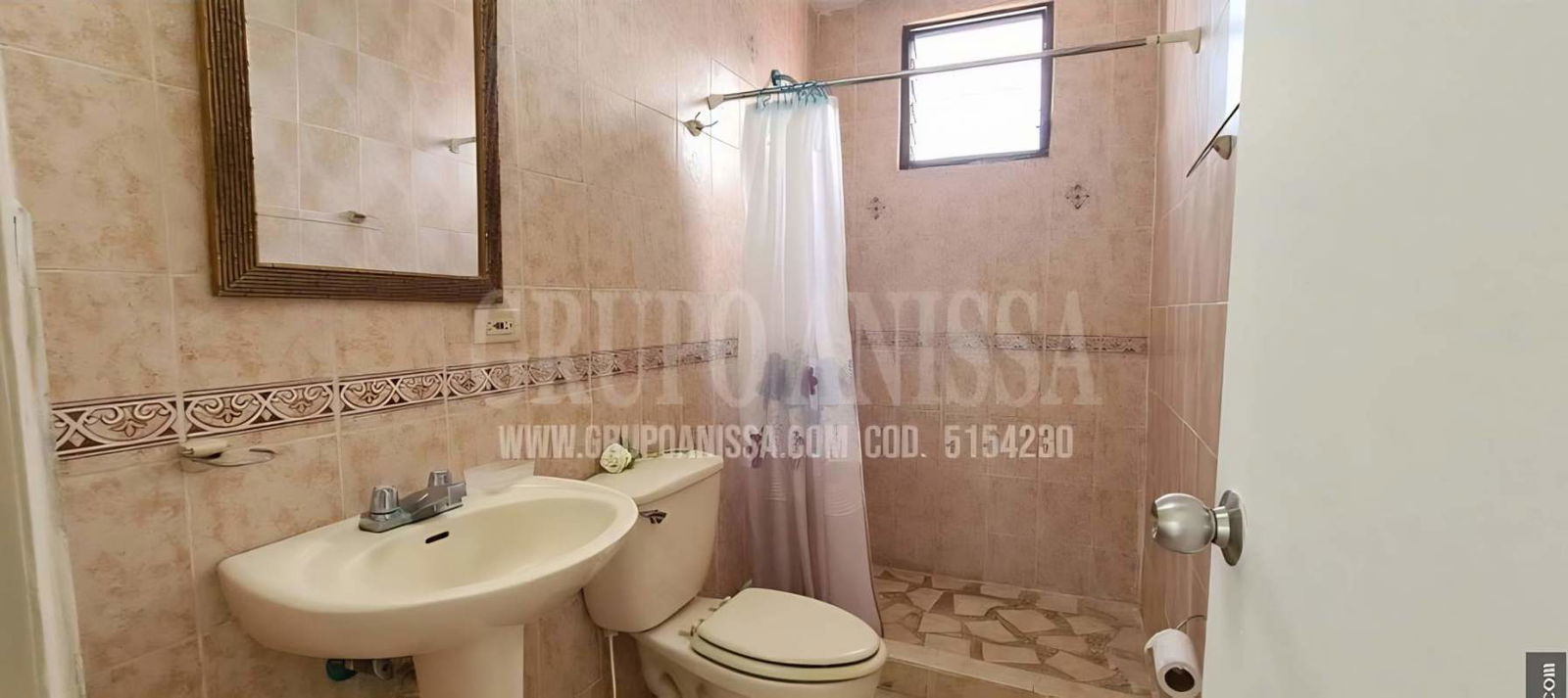 Beige tile bathroom with walk-in shower toilet and mirror PH Villa de las Fuentes Panama