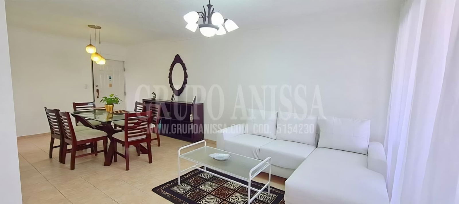 Living dining space with white sofa glass table tile flooring PH Villa de las Fuentes Panama