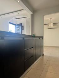 Contemporary kitchen with dark cabinetry and open design Montelimar Costa Verde Panama