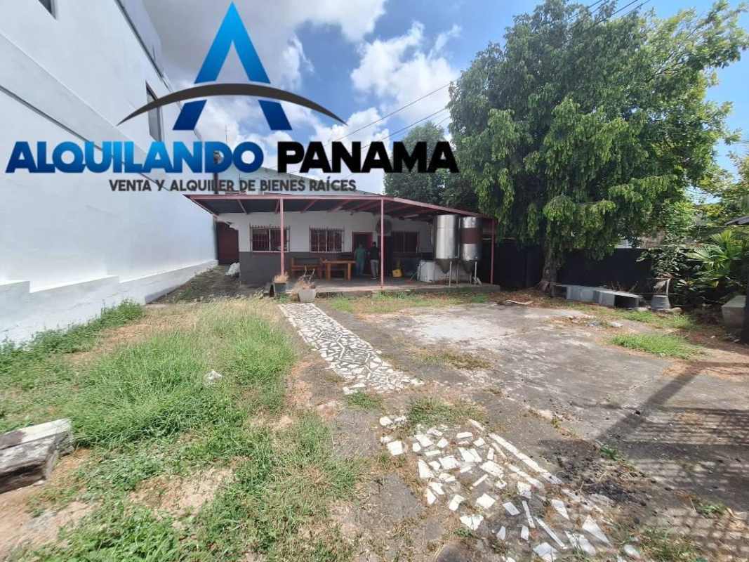 Utility sink and exterior work area with roll-up door at industrial warehouse Panama City