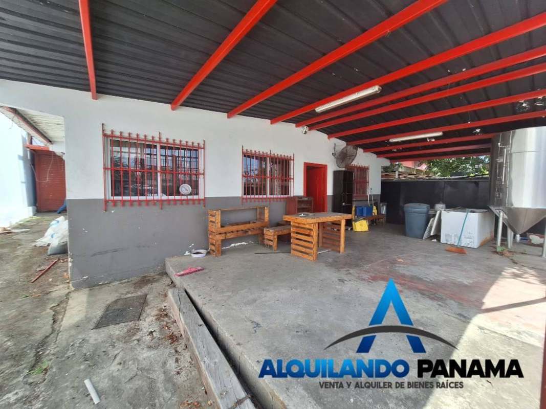 Covered patio workspace with metal roof and industrial equipment Panama City