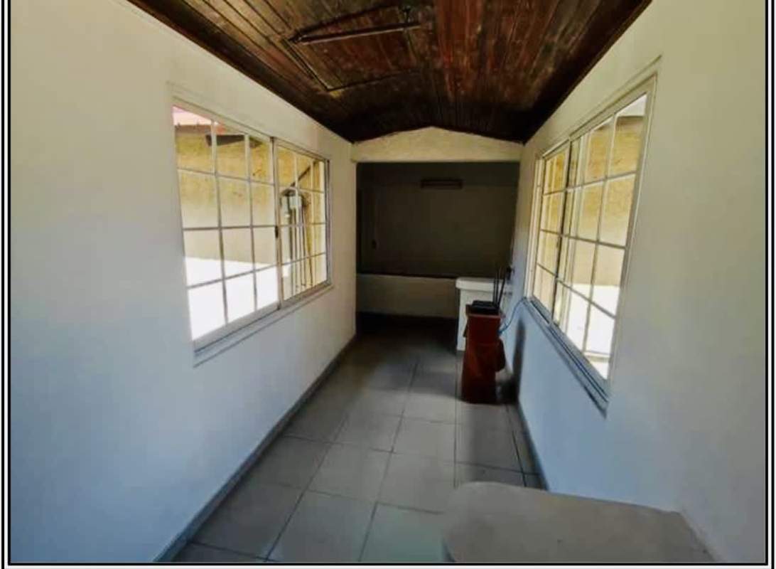 Tiled stairwell with decorative metal railing inside 3-level commercial/residential building Calidonia Panama