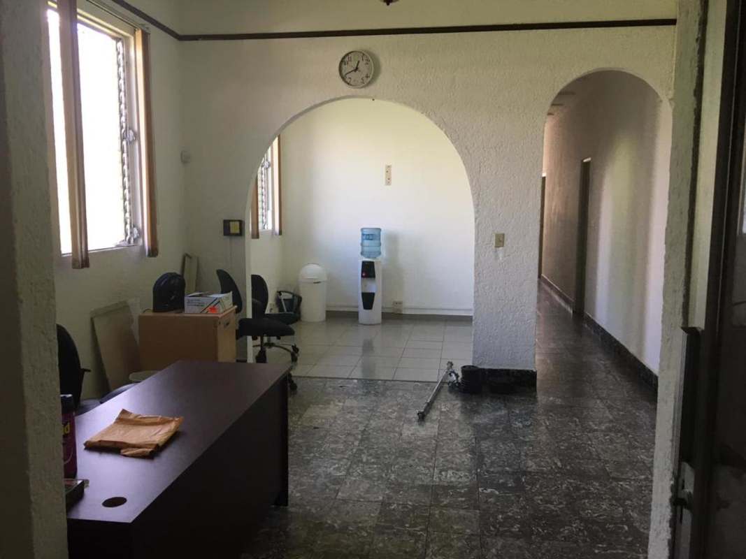 Indoor staircase with marble tile steps and black metal door in Calidonia Panama