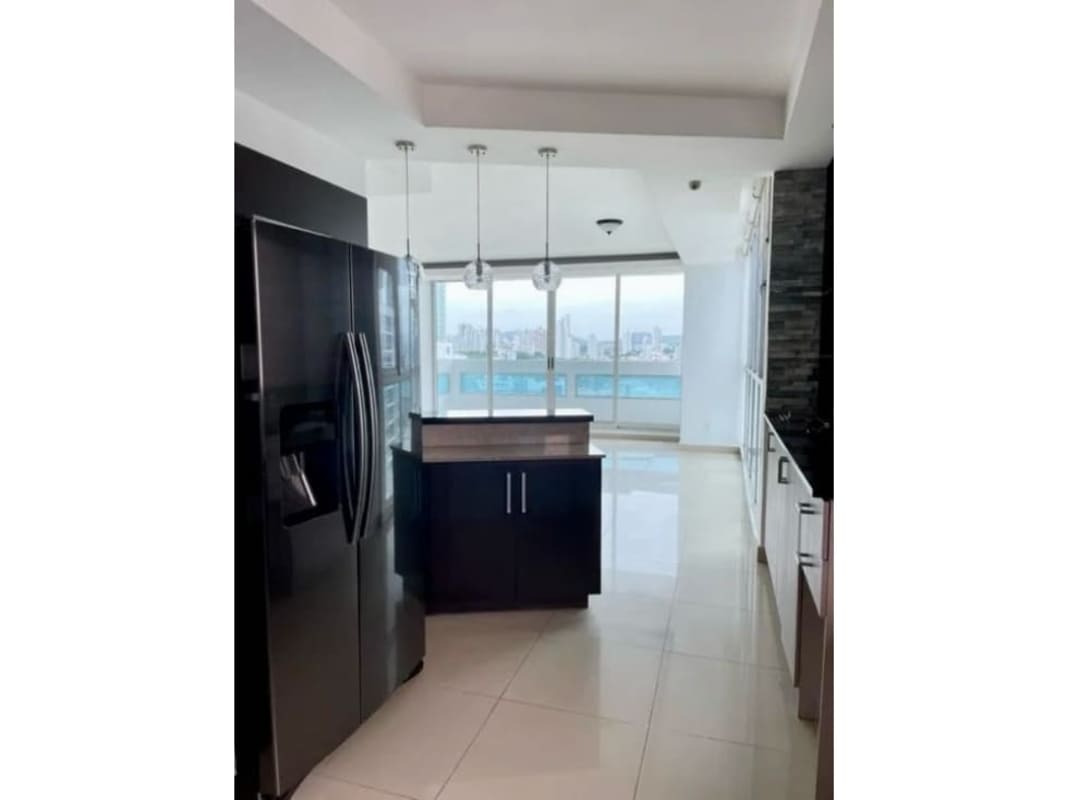 Sleek kitchen with ocean and city view from window in PH Coco del Mar Panama