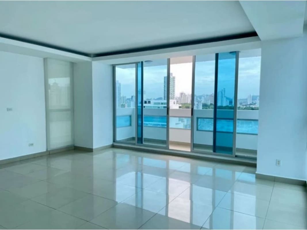 Bright open living and dining room with balcony access in PH Coco del Mar Panama City