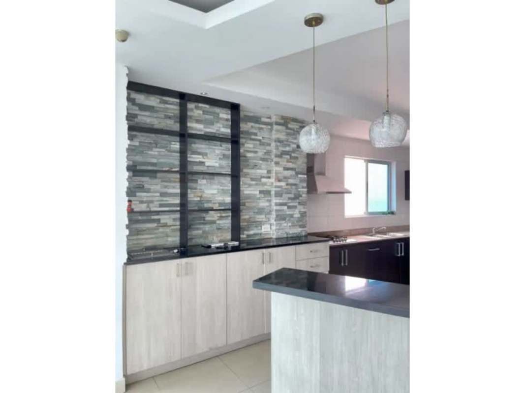 Modern kitchen with stone accent wall and pendants in PH Coco del Mar Panama