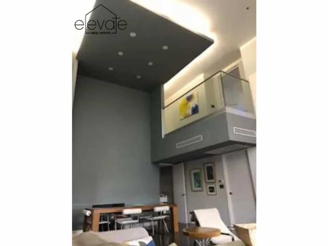 Loft apartment double-height window overlooking Panama City's skyline PH Portanova